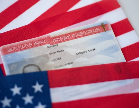 Employment Authorization card on USA Flag surface. Close up view.